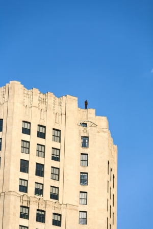 NEW YORK, USA - JULY 7: Facade of Empire State Building in the afternoon with iron statue of Man from atist Antony Gormley on the roof on July 7,2010 in New York, USA.のeditorial素材