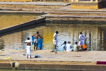 PUSHKAR, INDIA - OCT 20: people at rituell washing  in the holy lake on Oct 20,2012 in Pushkar, India. A ritual bath in the  Lake is considered to lead one to salvation.のeditorial素材