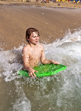 boy with surfboard in the oceanの写真素材