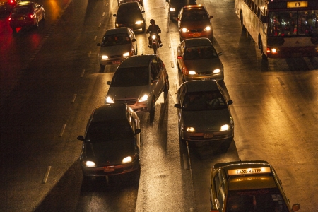 BANGKOK - MAY 5: heavy traffic at Main Road in Bangkok at night on may 05,2009 in Bangkok, Thailand.  It is already one of the world's most polluted cities and pollution by car emissions is one main reason.のeditorial素材