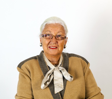 portrait of smiling attractive senior woman in front of a white background