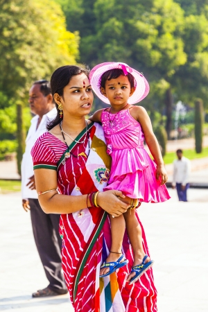 AGRA, INDIA - OCT 18: mother with child visit Taj Mahal, Agra, India on Oct 18, 2012. The Taj Mahal is a mausoleum located in Agra, India and is one of the most recognizable structures in the worldのeditorial素材