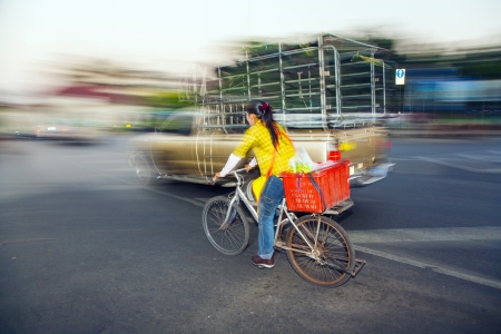 BANGKOK - DEC 23:  lady drives home with bike from the market Pak Khlong Thalat on DEC 23,2009 in Bangkok, Thailand. The market was established by king Rama I 1782 and is the oldest flower market in Thailand.のeditorial素材