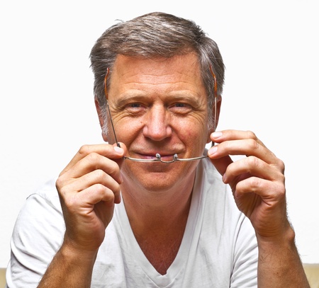 smiling man with reading glassesの写真素材