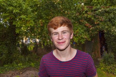 portrait of attractive happy smiling boy in the gardenの写真素材