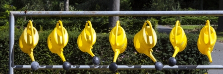 watering cans hanging for use at the cemetery