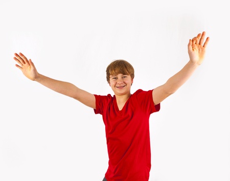 handsome boy has fun gesturing with the arms in the studioの写真素材