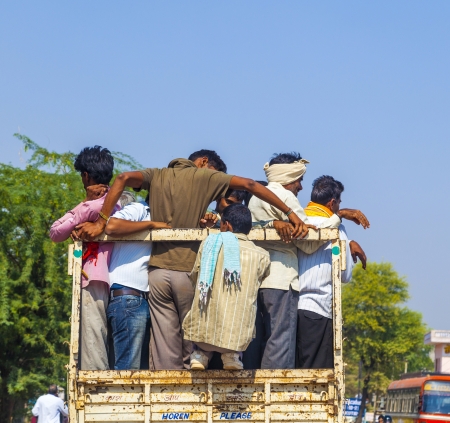 DAOLA, INDIA - 25 OCT: people on highway 71 in overloaded truck on OCT 24, 2012 in Daoloa, India. Overload ist the most dangerous reason for car accidents.のeditorial素材