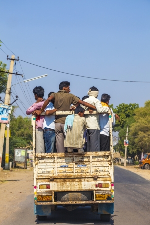 DAOLA, INDIA - 25 OCT: people on highway 71 in overloaded truck on OCT 24, 2012 in Daoloa, India. Overload ist the most dangerous reason for car accidents.のeditorial素材