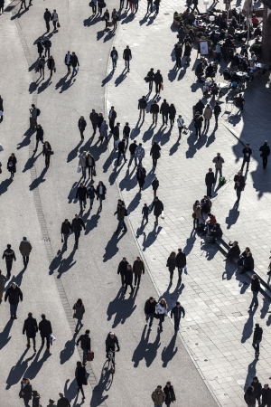people walk along the Zeil in Midday in Frankfurt with large shadows. The zeil is one of the most famous and busiest shopping streets in Germany.のeditorial素材