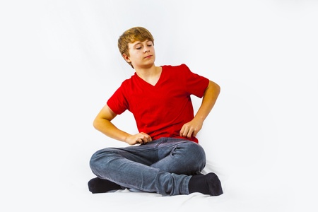 cute handsome boy sitting at the floorの写真素材