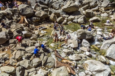 YOSEMITE PARK, USA - JULY 22: tourists cool their legs in the lake of the lower Yosemite waterfall on July 22, 2008 in Yosemite, USA. In 1890, the U.S. Congress declared that area as National park. The majestic Yosemite Waterfalls are visited by millions のeditorial素材