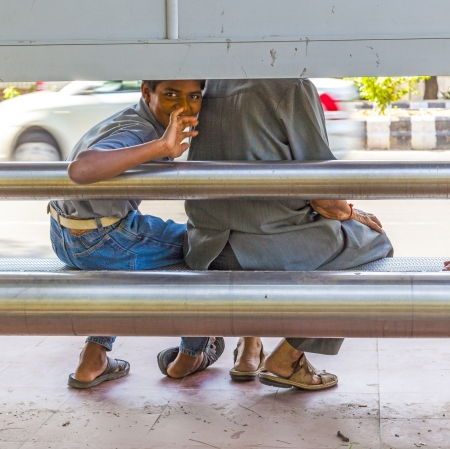 DELHI, INDIA - OCTOBER 14: boy waits for the bus on October 14,2012 in Delhi, India. Bus transportatio in India is very cheap and the main transportation equipment in India.のeditorial素材