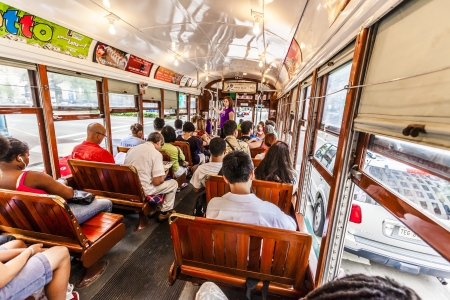 NEW ORLEANS - JULY 15: people travel with the famous old Street car St. Charles line on July 15, 2013 in New Orleans, USA.  It is the oldest continually operating street car line in the world.のeditorial素材