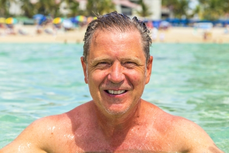 handsome man has fun swimming in the oceanの写真素材