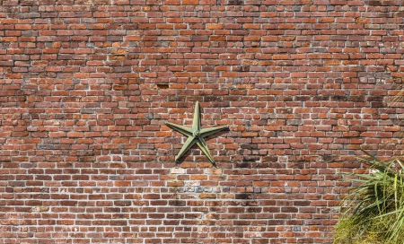 Background of brick wall texture with architectonic star construction to keep stabilityの写真素材