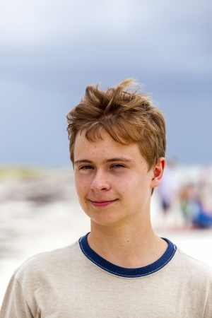 young happy handsome boy at the beachの写真素材