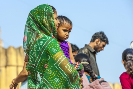 JAIPUR, INDIA - OCTOBER 19  woman begs for money with her child in arm on October 19, 2012 in Jaipur, India  Begging with babies is popular at touristic spots のeditorial素材
