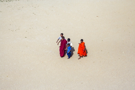 RUWANWELISEA, SRI LANKA - AUG 8  young monk guides his child friends to the temple  on August 8, 2005 in Ruwanwelisea, Sri Lanka  The underage poor boys, too young to understand religion or politics are often  being coerced into joining the monasteries のeditorial素材
