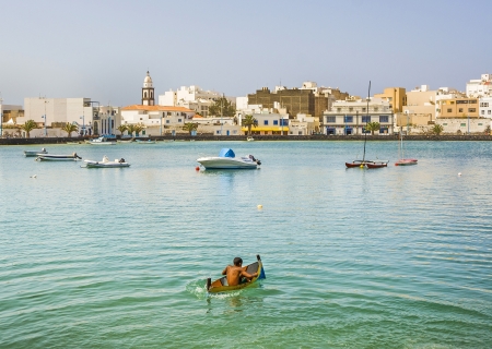 ARRECIFE, SPAIN - AUGUST 9  boy paddles with his small canoe at the charco de San Gines on August 9, 2007 in Arrecife, Spain  The harbor area was remodelled by Canarian architect Cesar Manrique in 1984 のeditorial素材