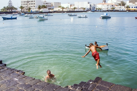 ARRECIFE, SPAIN - AUGUST 9  local children play at the charco de San Gines on August 9, 2007 in Arrecife, Spain  The harbor area was remodelled by Canarian architect Cesar Manrique in 1984 のeditorial素材