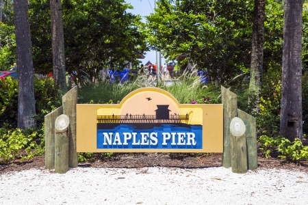 NAPLES, USA - JULY 27: sign and symbol for the famous Naples Pier on July 27, 2013 in Naples, USA. The Naples Pier was originally built in 1888 as a freight and passenger dock.のeditorial素材