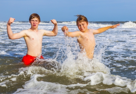 boys having fun in the beautiful clear seaの写真素材