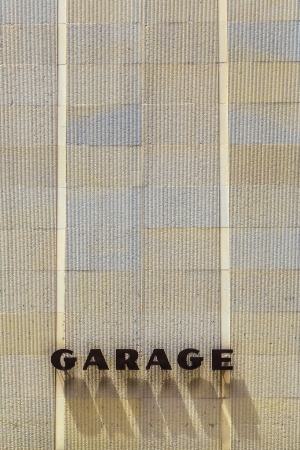 HOUSTON, USA - JULY 11  garage sign with shadow of letters on July 11, 2013 in Houston, USA  The garage sign is splaced at a  skyscraper facade of Houston historic district のeditorial素材