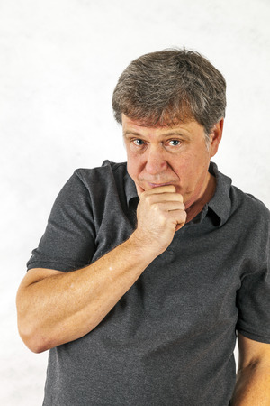 Portrait of a stylish  man standing and gesturing with his handsの写真素材