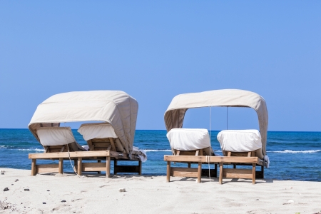 beach lounger for couples at the beach with blue sky and ocean viewの写真素材
