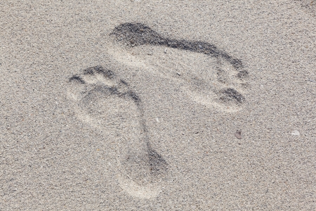 footprints  of man at the beach in vice versa directionの写真素材