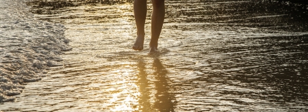 feet of a man in the fine sandの写真素材