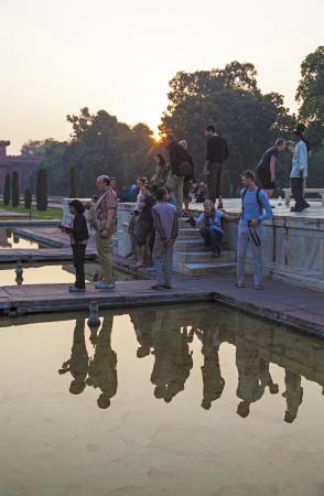AGRA, INDIA - NOV 11: Unidentified western tourists take pictures from a scenic point of the white marble mausoleum Taj Mahal on November 15, 2011 in Agra, India. 2,5 Mio. local tourists visit the UNESCO World heritage site yearly.のeditorial素材