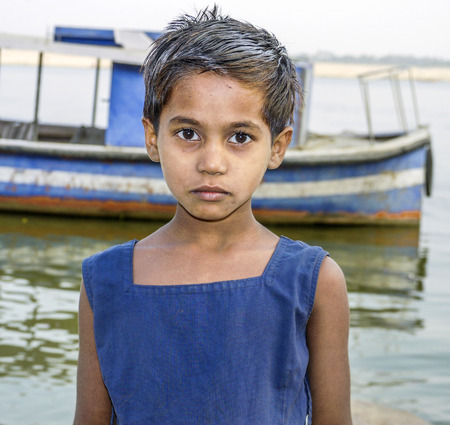 VARANASI, INDIA - DEC 11:  children pose for fotografers on December 11, 2011 in India, Varanasi. Some hope to get a gift and sometimes ask for money.のeditorial素材