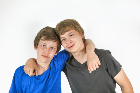 portrait of two friends hugging and posingの写真素材