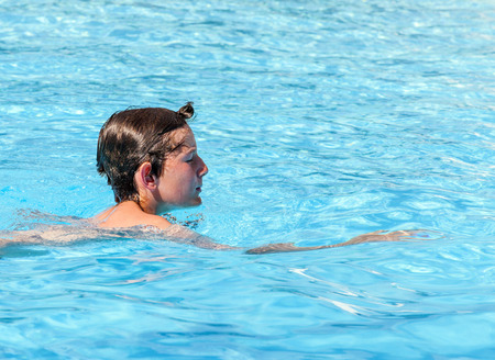 cute boy swimming in the pool