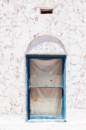 old peeling white wall with window in detailの写真素材