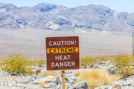 A road sign in Death Valley warning travelers of Caution Extreme Heat Dangerの写真素材