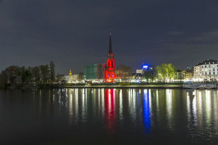 FRANKFURT - APRIL 4: Illuminated  church at river Mainat night on April 4, 2014 in Frankfurt, Germany. The festival Luminale takes place in Frankfurt every 2 years and lasts one week.のeditorial素材