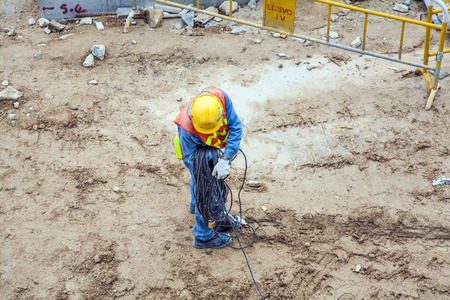VICTORIA, HONG KONG - JAN 8: worker with electric cable and helmet on Jan 8, 2010 in Victoria, Hong...