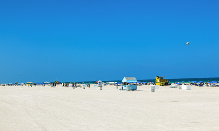 MIAMI, USA - JULY 27: people enjoy beach life on July 27, 2010 in Miami, USA. South beach is famous for its wooden lifeguard towers which are designed in Art deco style.のeditorial素材