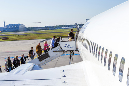FRANKFURT, GERMANY - MAY 4: people board the Lufthansa aircraft on May 4, 2014 in Frankfurt, Germany. Frankfurt is  the busiest airport in Germany and one of the mosy busy in Europe.のeditorial素材