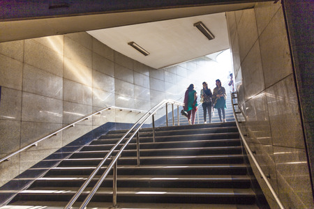 DELHI, INDIA - NOV 9: people enter the metro stationearly morning on November 9, 2011 in Delhi, India. It is one of the largest metro networks in the world. The network consists of six lines with 142 Stations.のeditorial素材