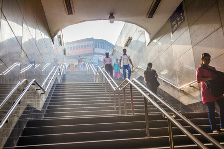 DELHI, INDIA - NOV 9: people enter the metro stationearly morning on November 9, 2011 in Delhi, India. It is one of the largest metro networks in the world. The network consists of six lines with 142 Stations.のeditorial素材