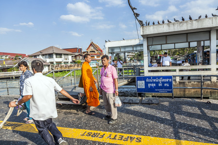BANGKOK, THAILAND - DEC 23, 2009: man lands his ferry and takes new passenger on board at the ferry in Bangkok, Thailand. The river ferry is operated by Chao Phraya Express boat company and prices are low.のeditorial素材