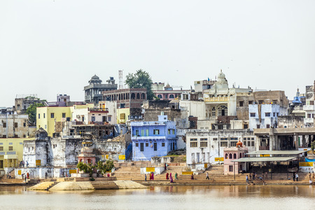 PUSHKAR, INDIA - OCTOBER 20, 2012: Pilgrims take ritual bathing in holy lake on in Pushkar,...