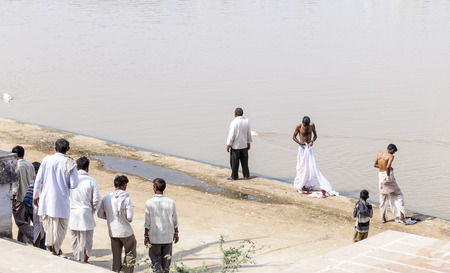PUSHKAR, INDIA - OCTOBER 20, 2012: Pilgrims take ritual bathing in holy lake on in Pushkar,...