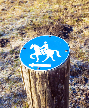 sign riding allowed on a wooden stumpの写真素材