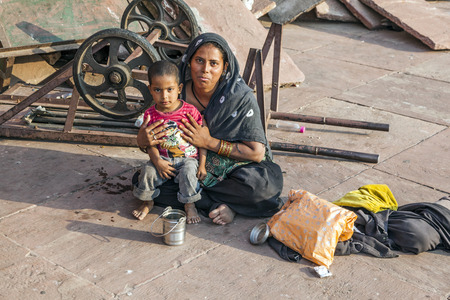 DELHI, INDIA - NOV 8, 2011: mother with child rests on the courtyard of Jama Masjid Mosque in Delhi, India. Jama Masjid is the principal mosque of Old Delhi in India.のeditorial素材