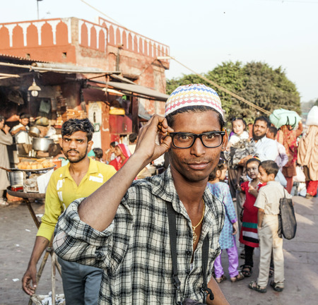 DELHI - NOV 8, 2011: portrait of young man with modern glasses at the Meena Bazaar Market in Delhi, India. Shah Jahan founded the bazaar in the 17th century inspired by the architecture of the Isfahan Bazaar.のeditorial素材